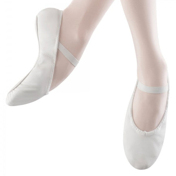 White ballet shoes with thin straps worn on a white background