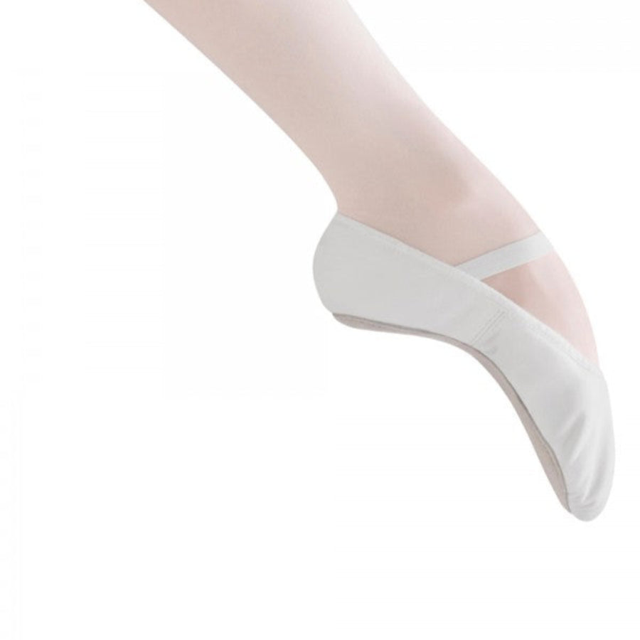 White ballet shoes with thin straps worn on a white background